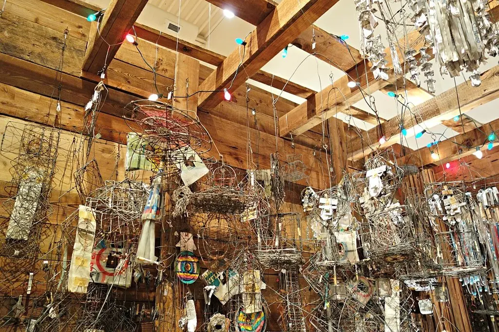 Hanging wire and foil constructions from Emery Blagdon's Healing Machine on display with strings of coloured lights.