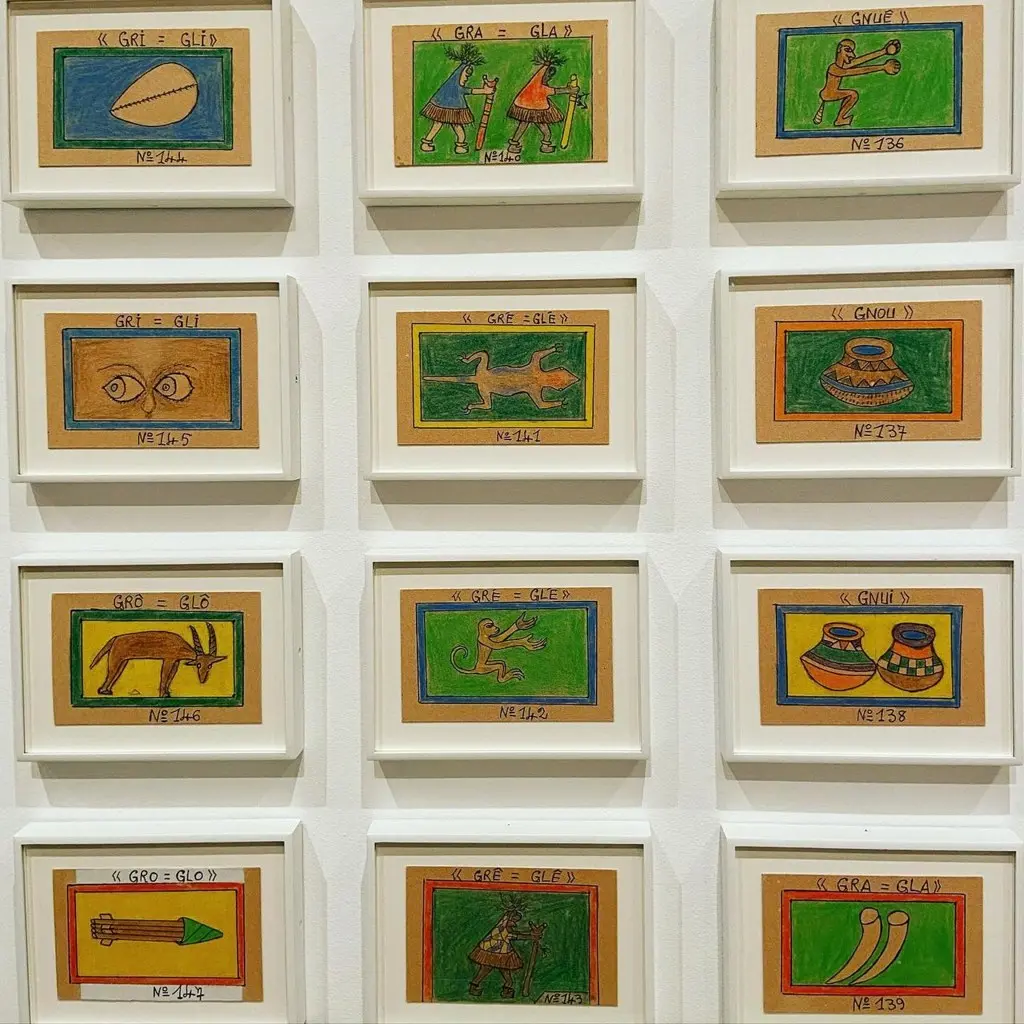 Framed cards from Frédéric Bruly Bouabré's Bété alphabet drawings on display.