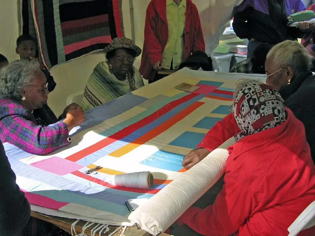Quiltmakers from Gee's Bend working at a quilting frame in Birmingham, Alabama, in 2005.