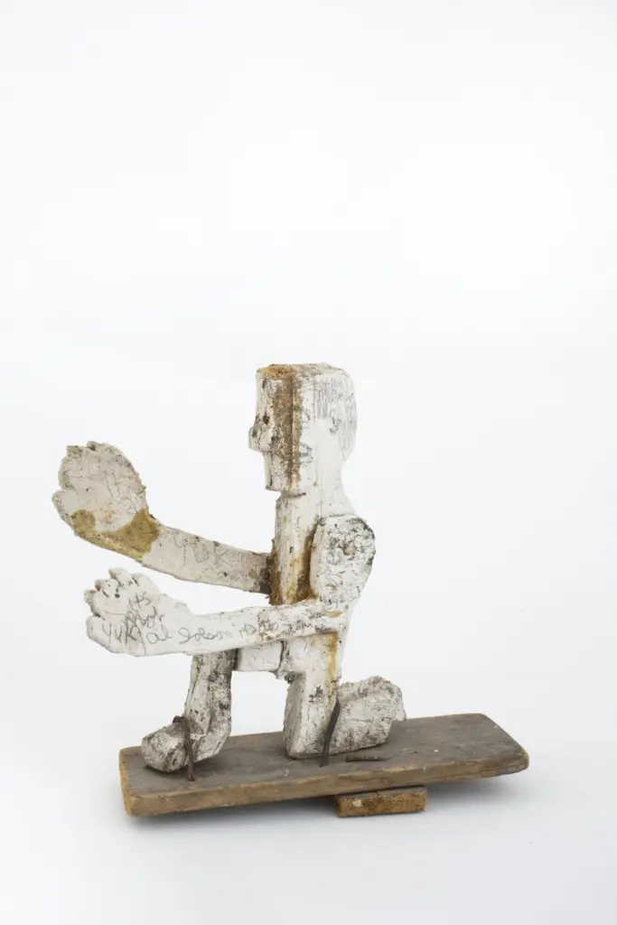 Untitled (Kneeling Man), a carved and pencilled wood sculpture by John Byam.