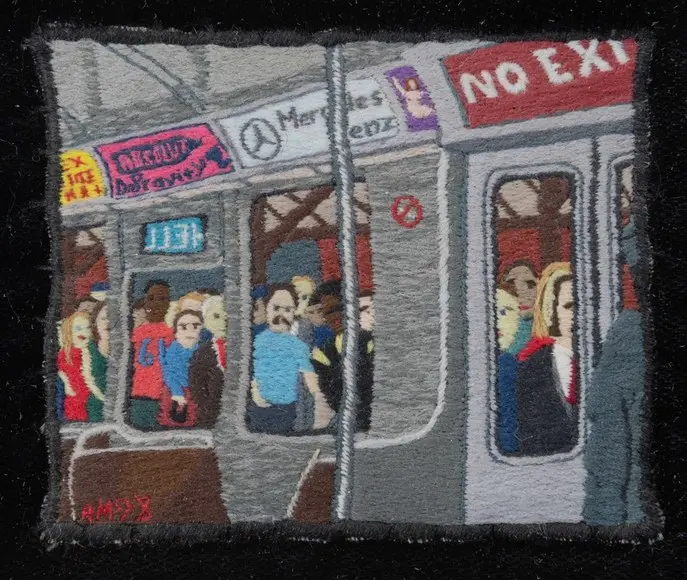 A miniature embroidery by Ray Materson depicting a crowded New York subway train.