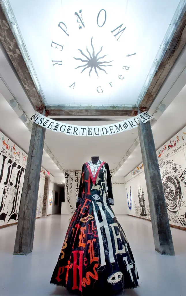 Sister Gertrude Morgan installation, her white robe among the Revelation texts.