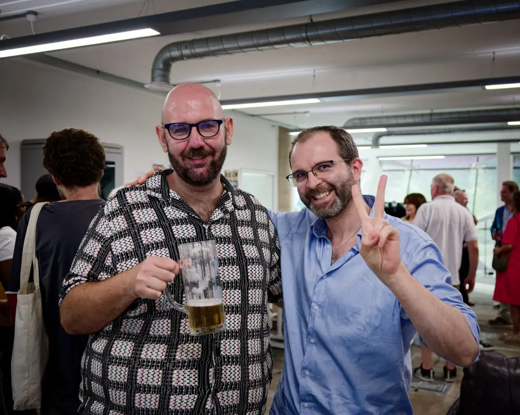 Two guests raise a toast at the Studio BRUT opening night, Swindon