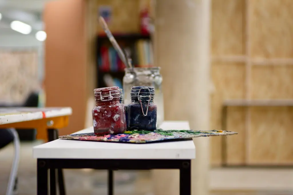 Artwork and materials laid out on a table in the studio