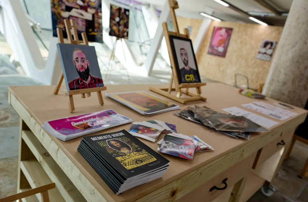 Framed paintings propped along the studio workbench