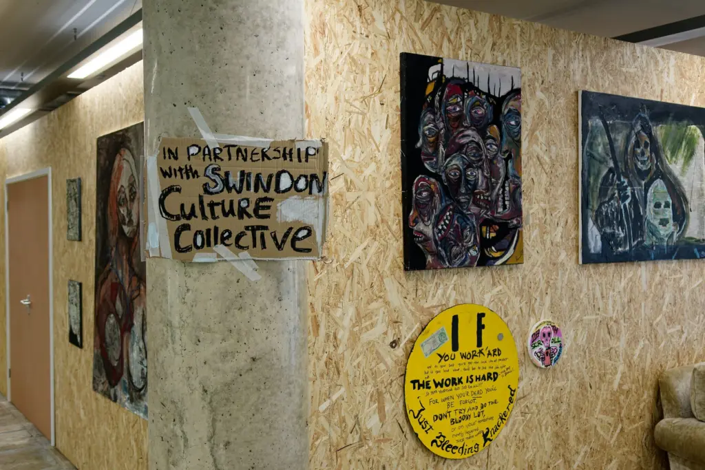The hand-painted Swindon Culture Collective partnership sign on the studio wall