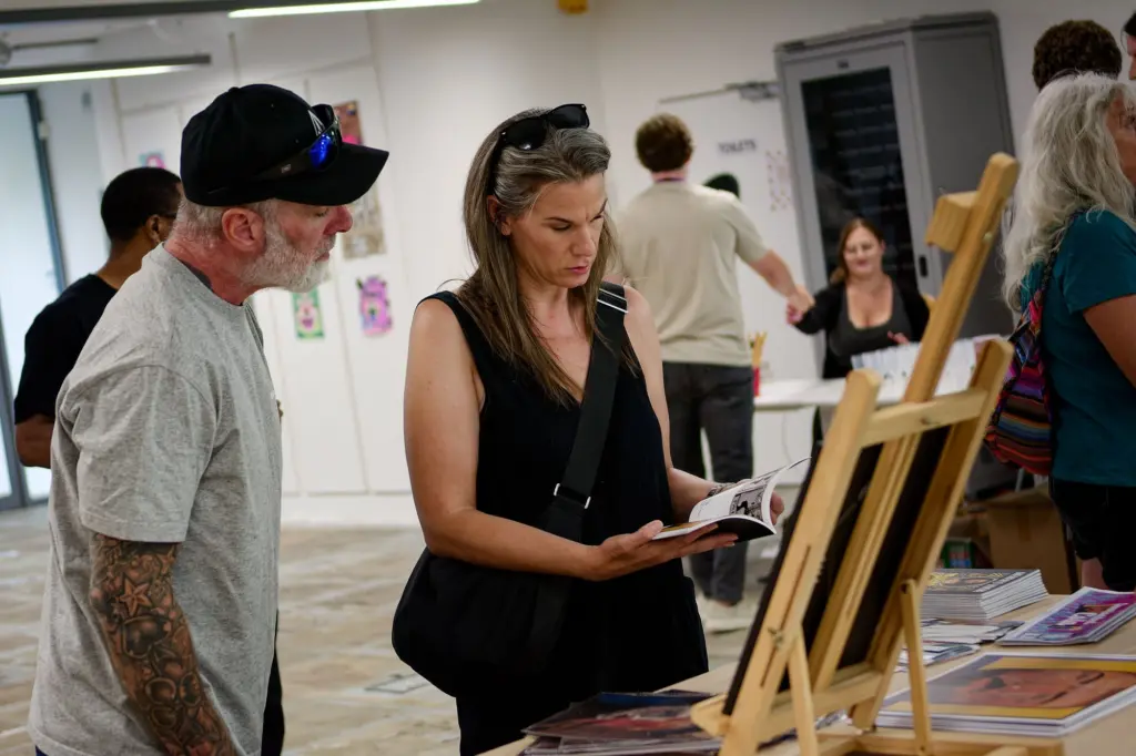 Guests looking at artwork propped on easels