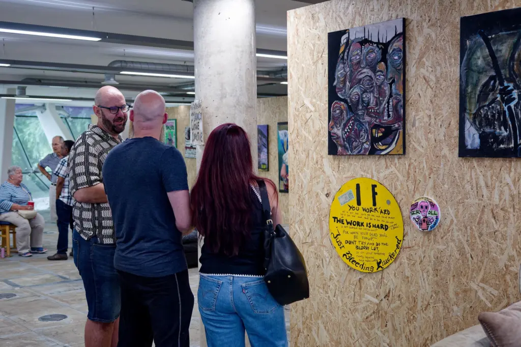 Guests gathered in the exhibition space in front of the glass wall