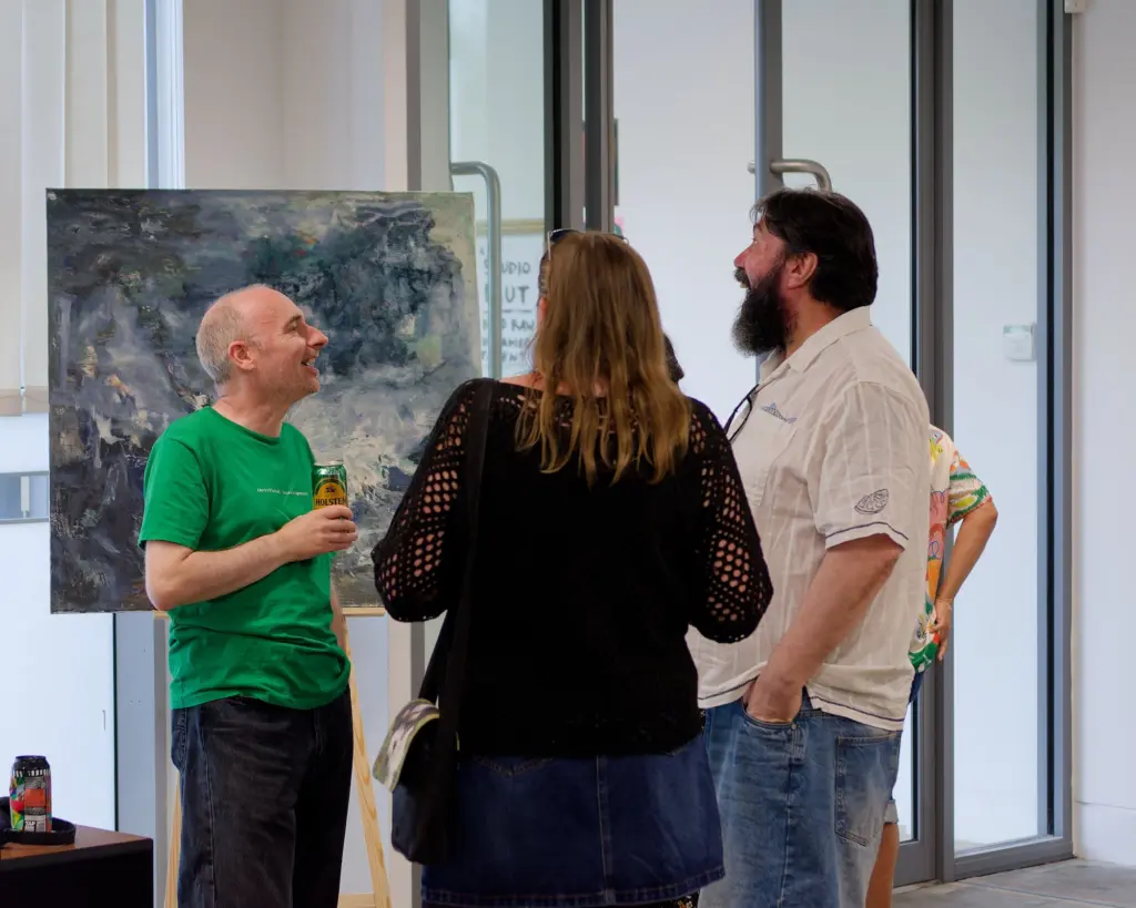 Guests in conversation across the exhibition space
