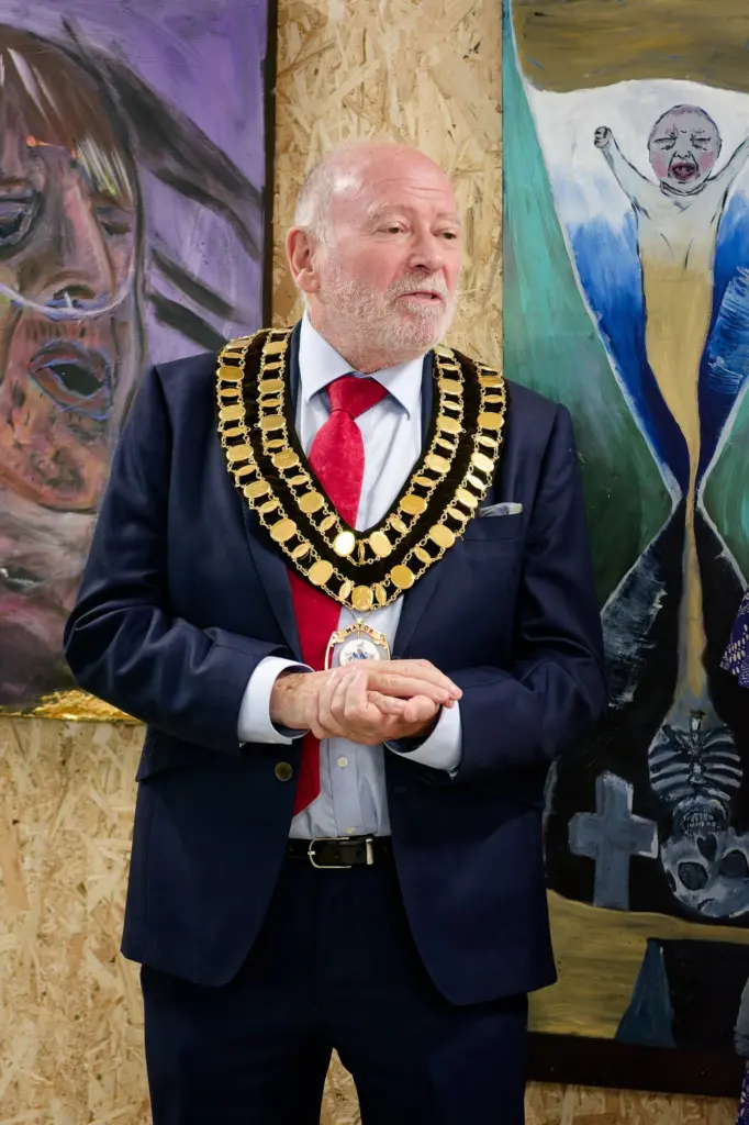 The Mayor of Swindon standing before a large painted canvas