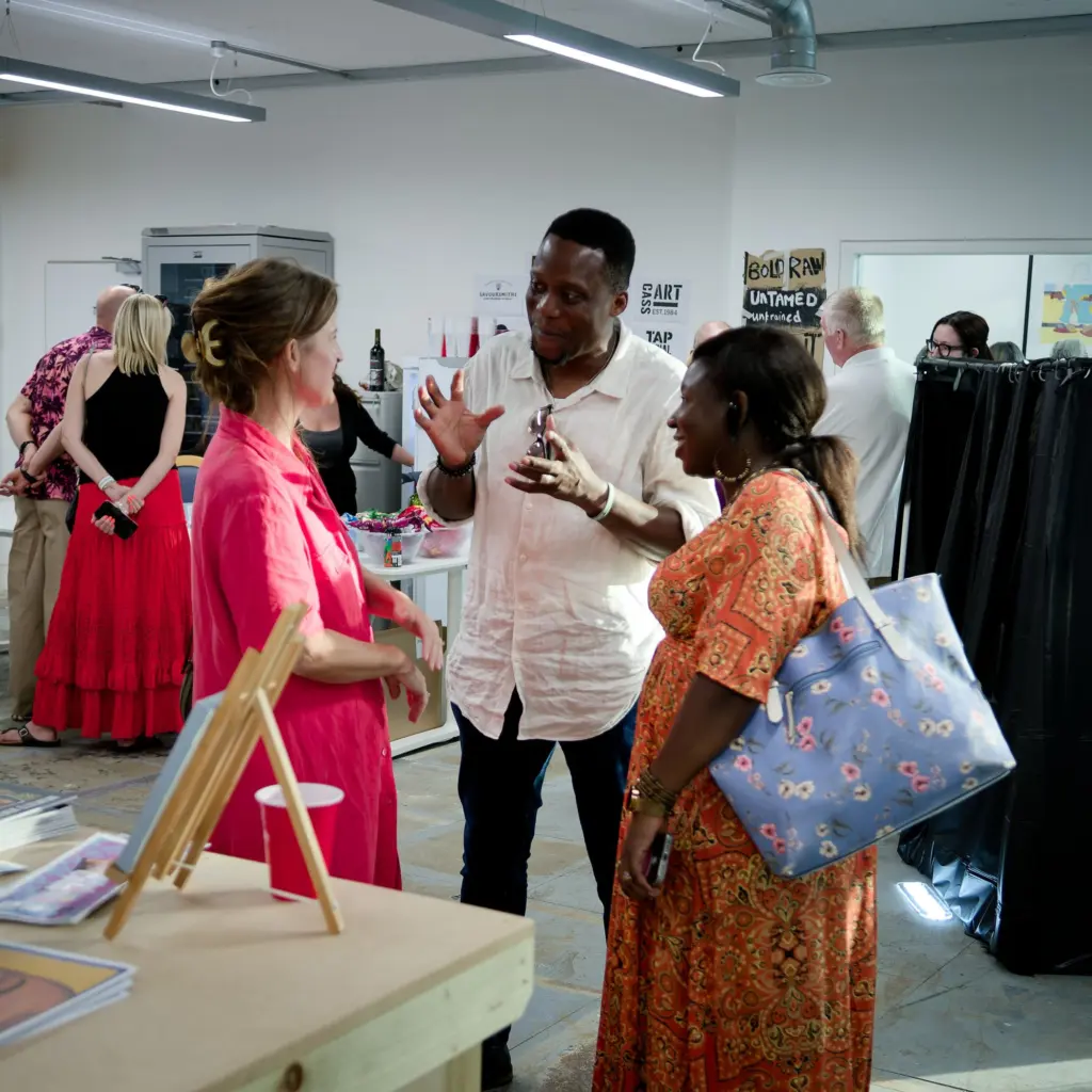 Guests talking and laughing in the exhibition space