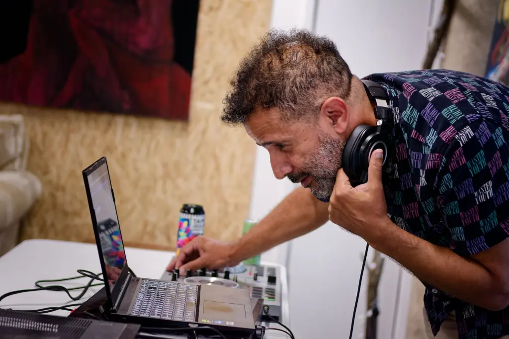The DJ setting up equipment at the opening