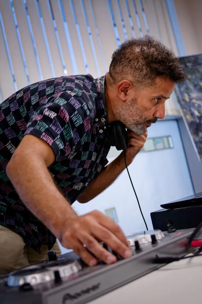 The DJ at work behind the decks