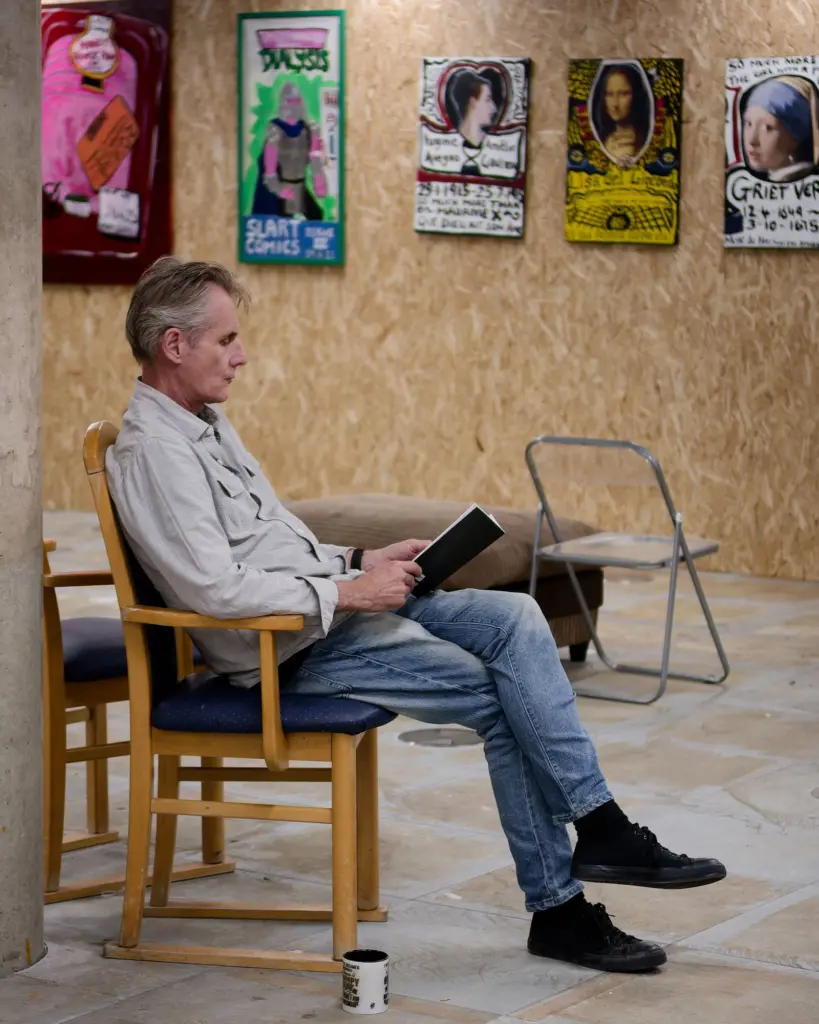 A guest seated reading in the exhibition space