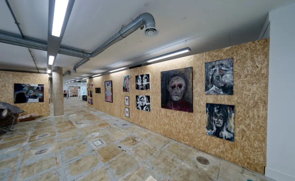The corridor of framed works at Arclite House before the doors opened