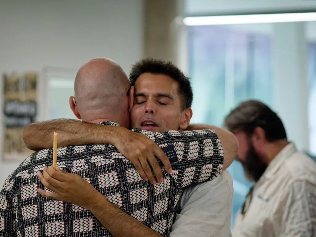 Two guests embracing at the opening night