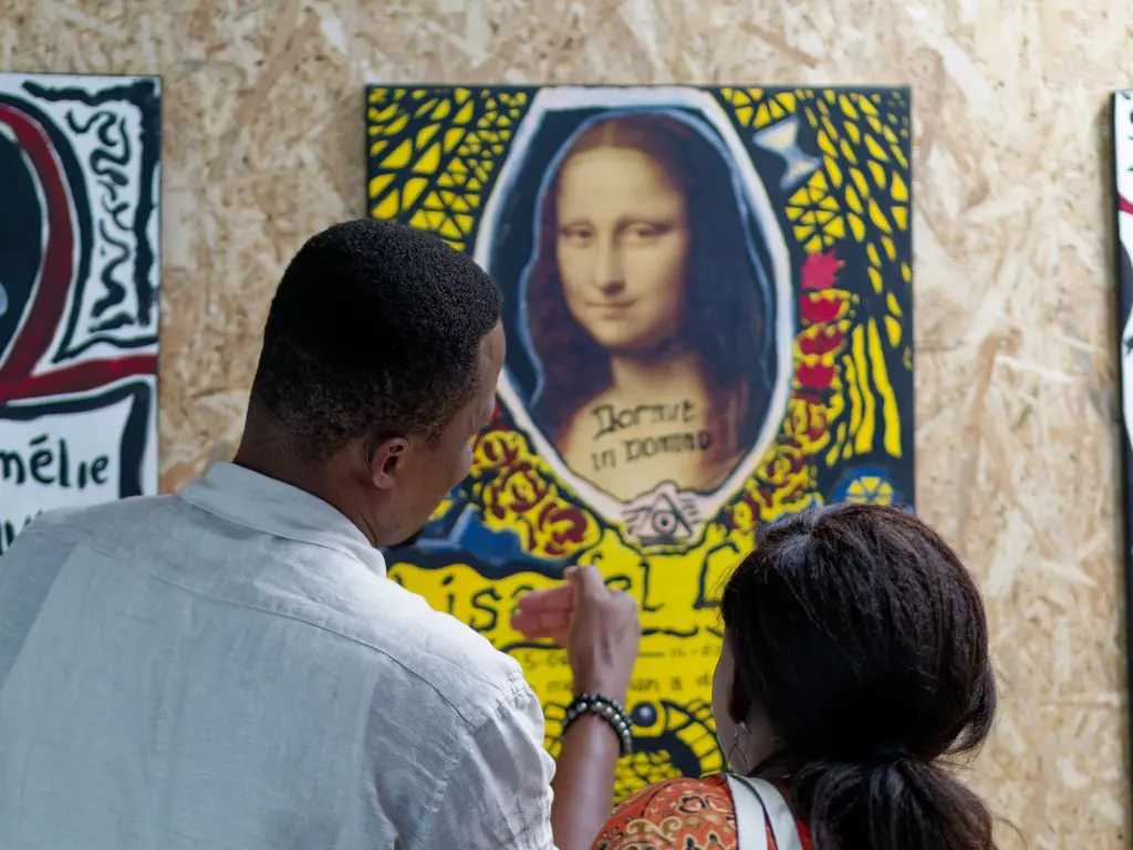 A guest looking at a painting of the Mona Lisa reimagined