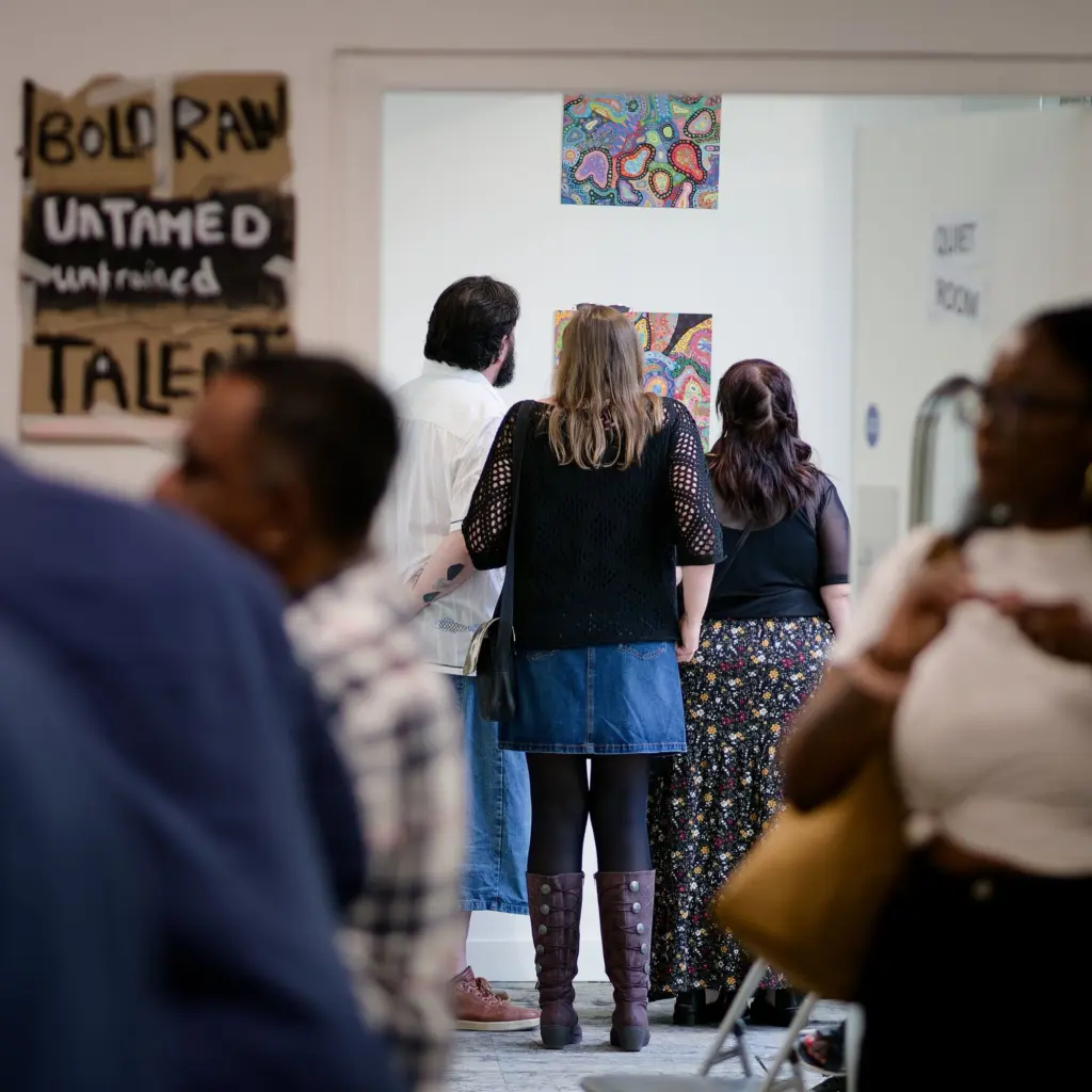Guests moving through the busy exhibition space