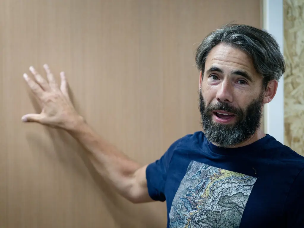 A guest gesturing mid-conversation at the opening