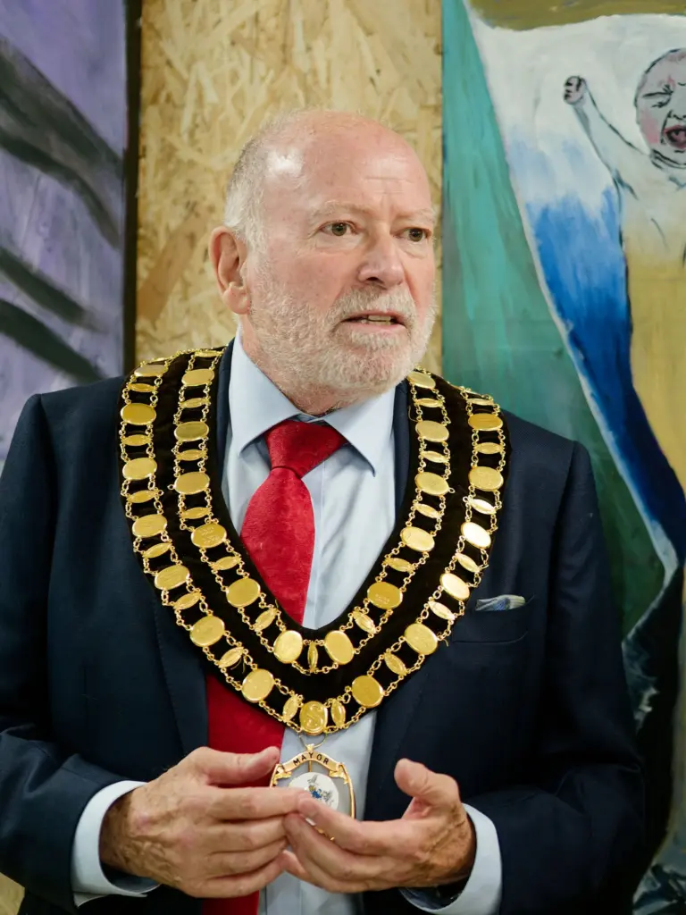 Councillor Neil Hopkins, Mayor of Swindon, giving the opening speech in front of SLART artwork